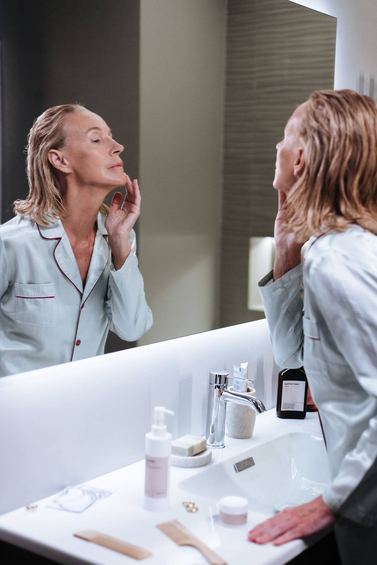 Senior woman following a calm morning routine in a bright bathroom