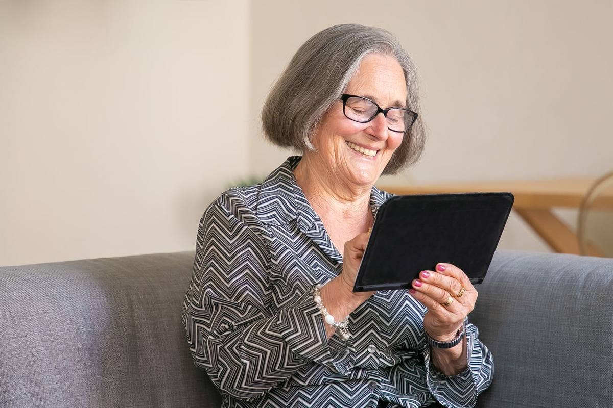 Smiling senior woman using a tablet for a video call